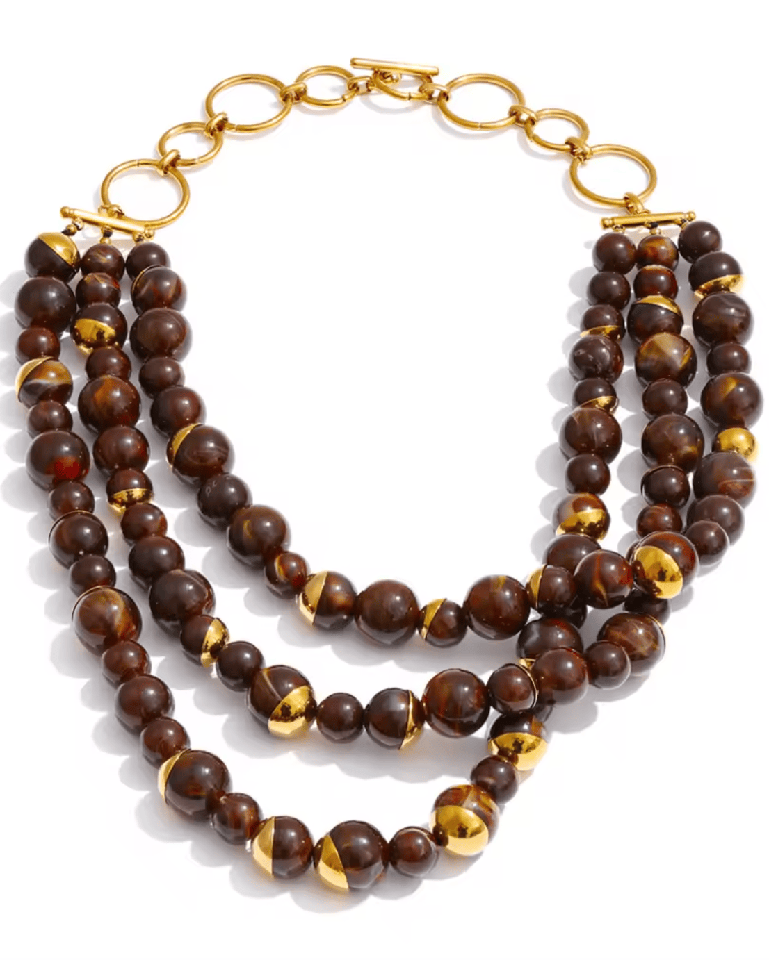 Stack of brown beaded necklaces with gold accents on a white background
