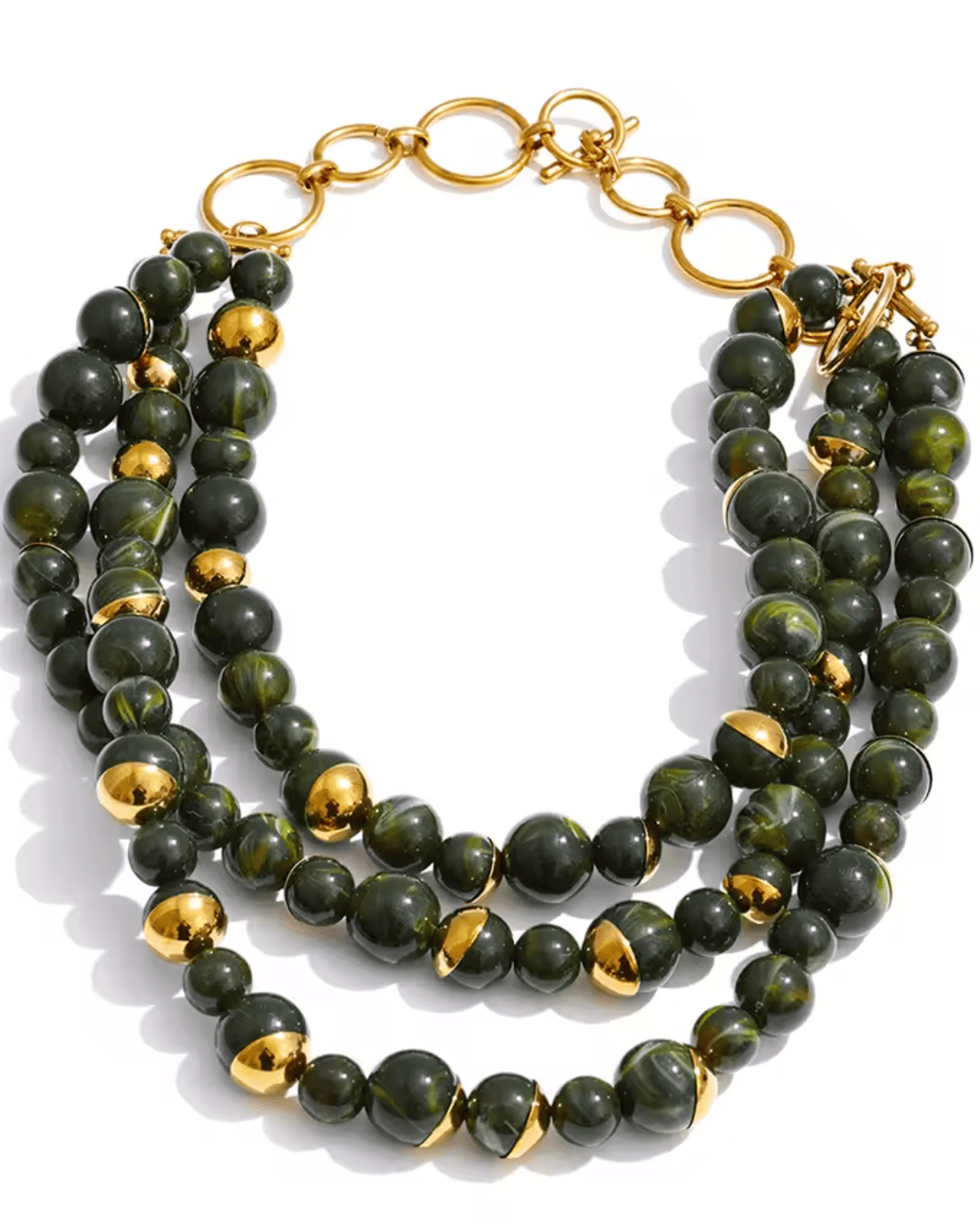 Stack of green beaded bracelets with gold accents on a white background